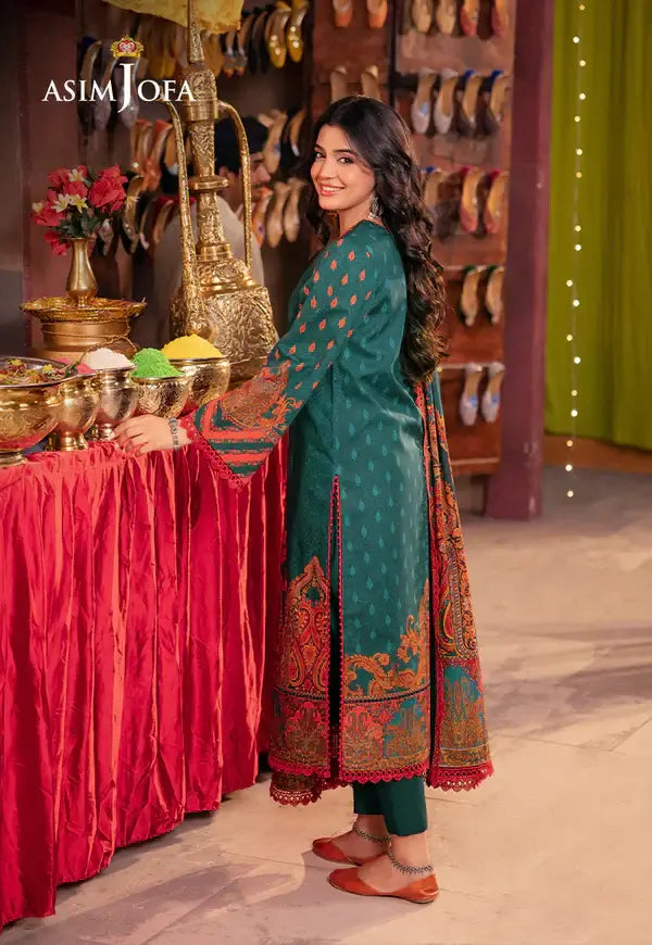 Woman in traditional attire standing in a decorated room with 'Asim Jofa' branding.