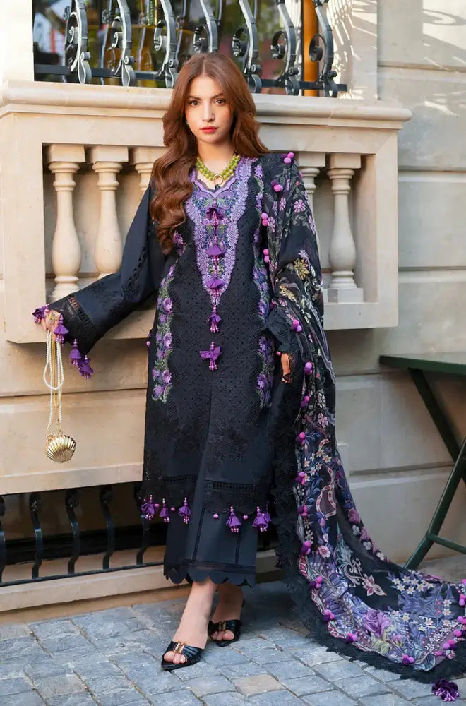 Woman in a dark floral dress with a matching shawl standing outdoors.