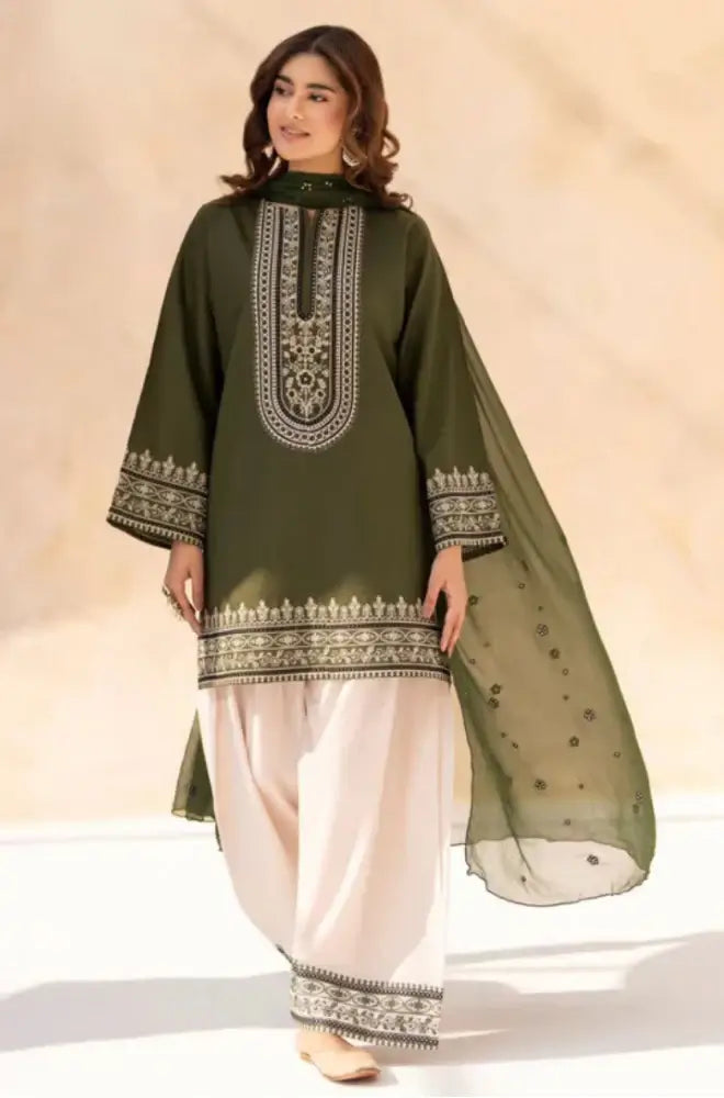 Woman wearing a green embroidered traditional outfit with a beige background