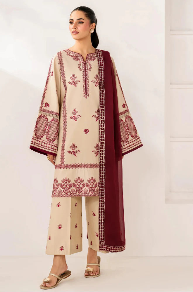 Woman wearing a cream and red embroidered traditional outfit with a matching dupatta on a white background